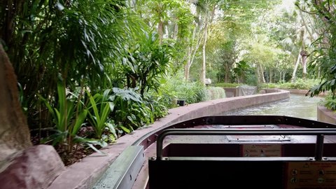 Point of view, Amazon River Quest water ride at Singapore river wonders, safari zoo, mandai reserves, cruising through beautiful lush green vegetations and foliage environment with sunlight.