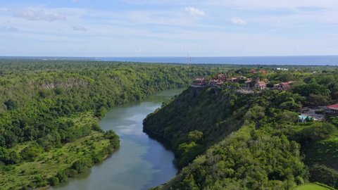 Altos de Chavon village on cliff overlooks river, La Romana; aerial push in