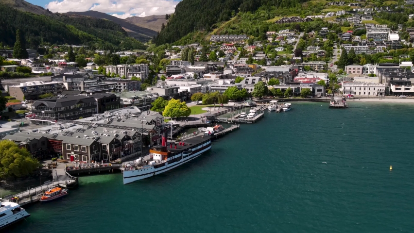 TSS Earnslaw historic coal-fired steamship in Queenstown port. Beautiful sunny day in New Zealand famous resort town on lake Wakatipu Royalty-Free Stock Footage #1087166972