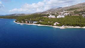 View of the sea coast in the town of Trogir. Medena hotel. Beach and yachts in the Adriatic Sea. Mountains in the background. Drone Video. Dalmatia. Croatia. Europe