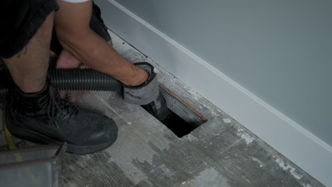 Home Duct Cleaning Services, ventilation cleaner man at work with tool on the floor. Slow motion