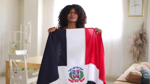 patriotic dominican woman hugging dominican flag