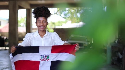 patriotic dominican woman hugging dominican flag