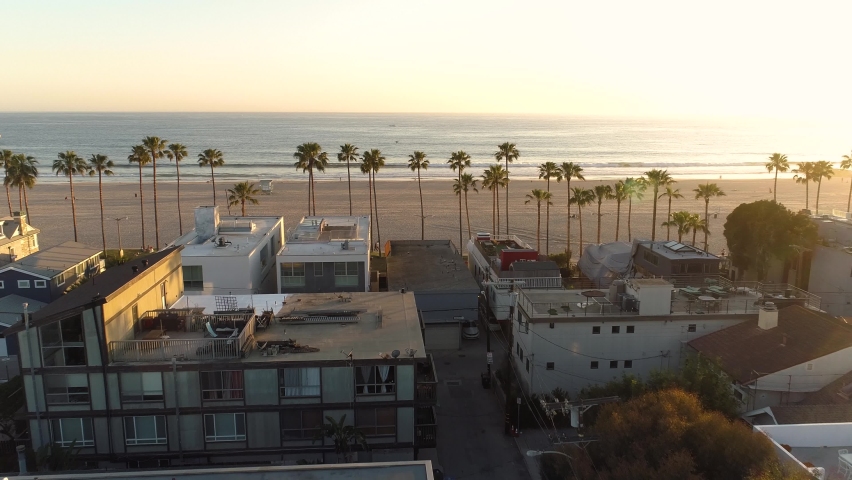 Venice Beach, California USA. Aerial View of Waterfront Buildings, Sandy Coast and Sunset Sun on Skyline, Drone Shot