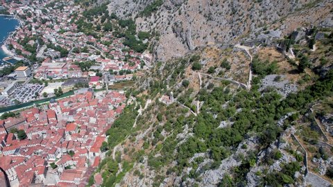 Descending Upon Small Medieval Stone Church in Mountainside Ladder of Kotor Montenegro Summer Day Aerial Drone 4k