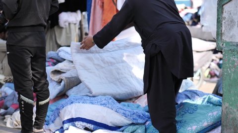 Karachi , Pakistan - 01 31 2022: Colorful thick carpets or mattresses on sale in the street market shops in Saddar Bazaar, Pakistan
