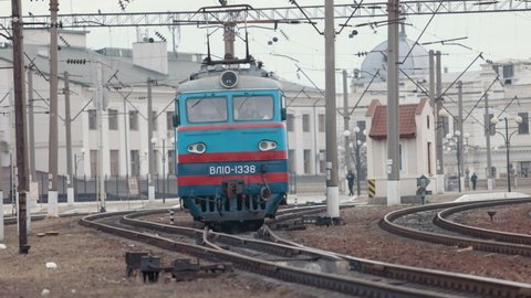 Railway locomotive. Front view. Old soviet diesel vehicle. Front view of soviet powerful diesel locomotive on railroad. Train at the railway station. Suburban electric train.