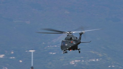 Thiene Italy, OCTOBER, 16, 2021 Military helicopter climbs vertically at high speed in the blue sky. Agusta Westland AW139 Leonardo HH139 of Italian Air Force