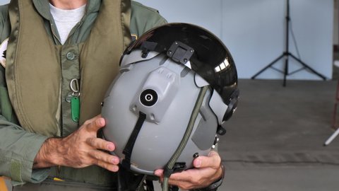 Gando Airport Gran Canaria Spain OCTOBER, 21, 2021 Military pilot holding the helmet he uses when flying high performance fighter aircraft