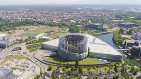 Inscription on video. Strasbourg, France. The complex of buildings is the European Parliament, the European Court of Human Rights, the Palace of Europe. Flames with dark fire, Aerial View, Point of i