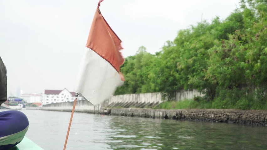 The small Indonesian flag flutters above the fishing boat