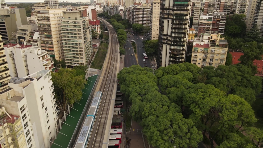 Aerial following shot of train driving in city central of Buenos Aires,Argentina