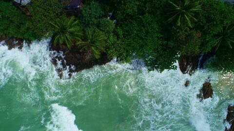 Aerial view Drone camera top down of seashore rocks in ocean Beautiful sea surface Amazing sea waves crashing on rocks seascape in Phuket island Thailand Aerial view drone 4k High quality footage