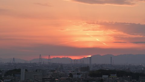 Nagoya, Aichi, Japan - Feb 14th 2022: Red sky pan from a high place. Overview of the sunset in the Japanese city of Nagoya with mountains in the background.