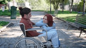 love, disability, romance - young woman listens to boyfriend using wheelchair - Powered by Shutterstock - Get 15% off with code: PIKWIZARD15