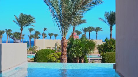 Cleopatra Luxury Resort Makadi hotel in Hurghada resort. View of the swimming pool and palms tree: Egypt, Hurghada - 3 December, 2021