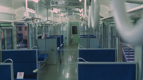 Nagoya.Japan-October 31.2019: Inside view of a train wagon in the railway museum in Nagoya Japan. Blue seats and grey walls. Windows. Camera slowly turning left. Selective focus.
