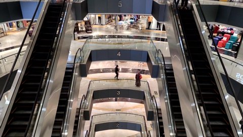 Surabaya, Indonesia - Feb 13 2022 : Top floor of Tunjungan Plaza 4 mall has this kind symmetrical design of escalators