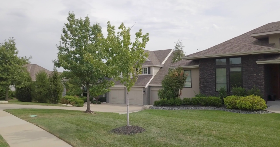 Drone flight over home in wealthy suburban neighborhood.