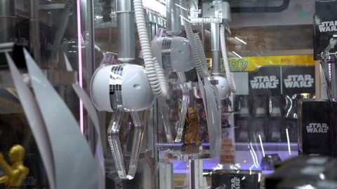 Tokyo, Japan-02 February, 2020: Arcade type robotic claw machine grabber game. Mechanical arm that selecting dolls and toys. Vending machines games to buy collections of toys background.