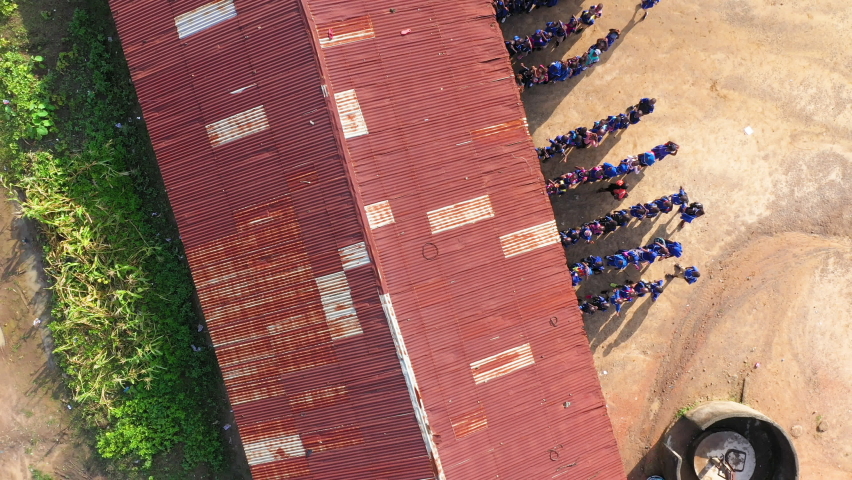 Aerial valley rural village school children Sierra Leone climb. Sierra Leone on coast of west Africa suffers extreme poverty and hunger. Tropical climate forest, jungle, mountain and savanna landscape