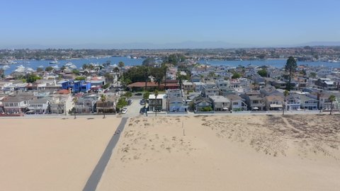 Aerial Pan Right of Beach Front Homes Newport Beach California