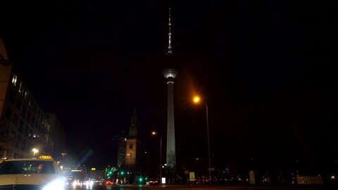 KARL LIEBKNECHT STRASSE AT NIGHT, BERLIN, GERMANY – 19 FEBRUARY 2019: Taxi on Karl Liebknecht Strasse near the Berliner Fernsehturm Television Tower, Berlin, Germany