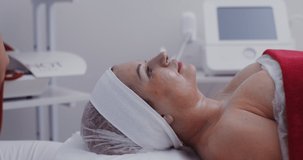 Lymphatic drainage tightening massage of the d collet area. Ionization and oxygenation of the skin of the decollete zone in a modern cosmetology clinic. Video in 4k, red komodo