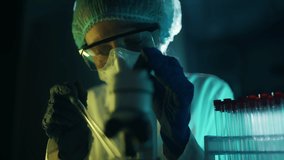 A woman scientist is looking into microscope, biochemical research. Scientific and medical lab instrument. A doctor is search for vaccine to treat diseases in laboratory for medicine study - Powered by Shutterstock - Get 15% off with code: PIKWIZARD15