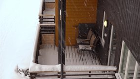Snow on empty balcony with no people during cold winter season in Norway - Snowfall during cold winter months - Static clip looking down at balcony in empty apartment building - Myrkdalen