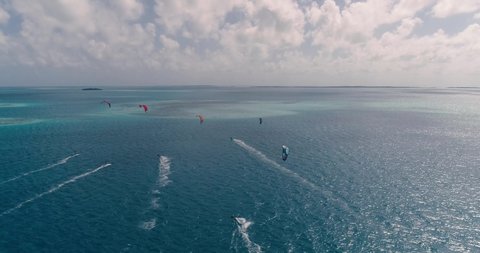 Kiters train. Surfing on a kiteboard on the sea on blue water Caribbean sea. Drone view landscape extreme sports in los Roques Venezuela. 