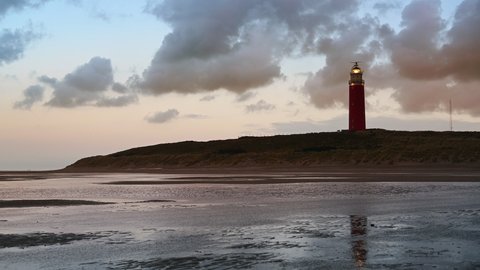 Lighthouse at the Wadden island Texel in the dunes during sunset after a stormy autumn day. The Eierland lighthouse is located at the North point of the island.