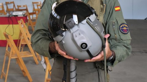 Gando Airport Gran Canaria Spain OCTOBER, 21, 2021 Close-up view of a military pilot showing the helmet with which he flies on extreme fighter jets