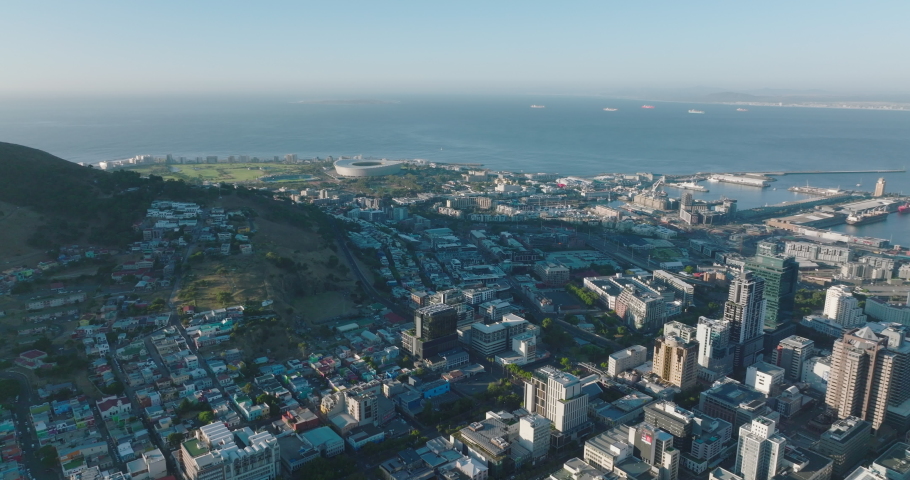 Aerial panoramic footage of various buildings in urban neighbourhood on seaside. Revealing high rise buildings in city centre. Cape Town, South Africa