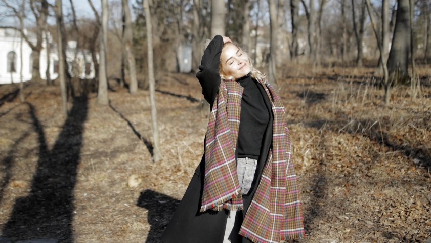 positive pretty European girl walking and turning around in spring autumn park forest with positive emotions, smile at camera, 4k slow motion, lovely  lady woman, sunny day, happy travel