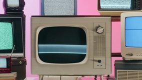 Old televisions with grey interference screen on pink red neon background. Vintage tv composition, nostalgia. Gray noise screen and glitches.