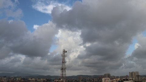 Mumbai, Maharashtra, India - 06.25.2021 : It is a time lapse of a cloudy monsoon evening with white, gey and black heavy clouds ready to rain.
