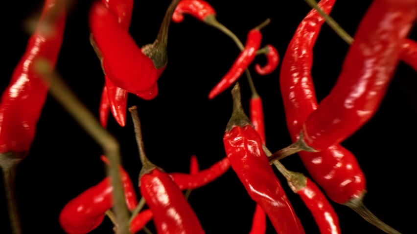 Super Slow Motion Shot of Flying Red Chilli Peppers. Filmed on High Speed Cinematic Camera at 1000 FPS.