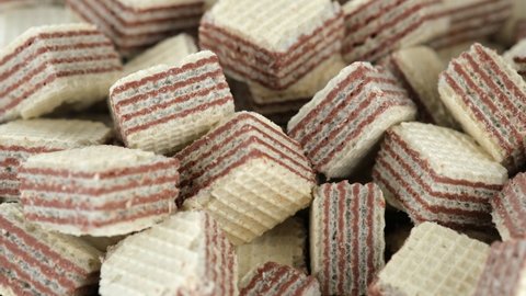 Square wafer biscuits close up. Sliding shot. Dessert cocoa wafers. 4K UHD video.