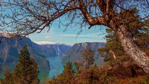 Overview of scenic Geirangerfjord between mountains with Waterfalls in Norway on a beautiful sunny morning in timelapse.