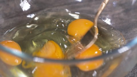 Mixing Eggs with a Fork, Making Scrambled Eggs in a Glass Bowl, Mixing Egg Yolk and White