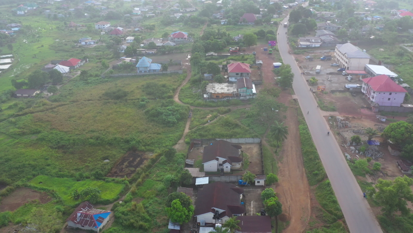 Aerial urban street traffic clouds Bo Sierra Leone Africa descend. Sierra Leone on  coast of west Africa suffers extreme poverty and hunger. Congested crowded homes and businesses. Tropical climate.