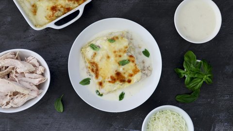Serving Chicken Lasagna with Basil and Creamy White Sauce