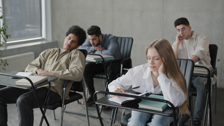 Young students employees workers unmotivated staff sitting in classroom listening boring lecture tedious coach teacher at corporate seminar bored participants fall asleep overloaded with information Royalty-Free Stock Footage #1087274204