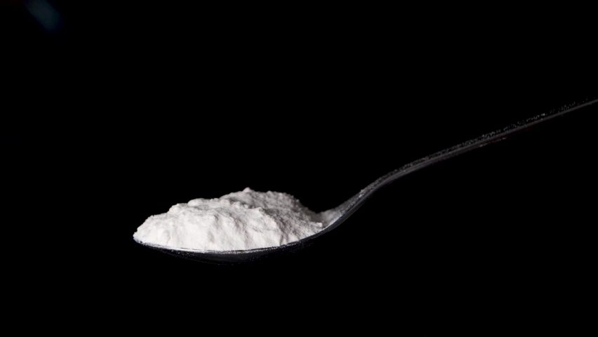 Blowing away flour powder from a spoon in slow motion, isolated black background Royalty-Free Stock Footage #1087275761
