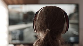 Girl Playing Racing Video Game in Game Console. Child Playing Computer Game in Headphones With Steering Wheel. Gamer With Headset Holding Steering Wheel Playing Video Game. Kid Gambling Addiction. - Powered by Shutterstock - Get 15% off with code: PIKWIZARD15