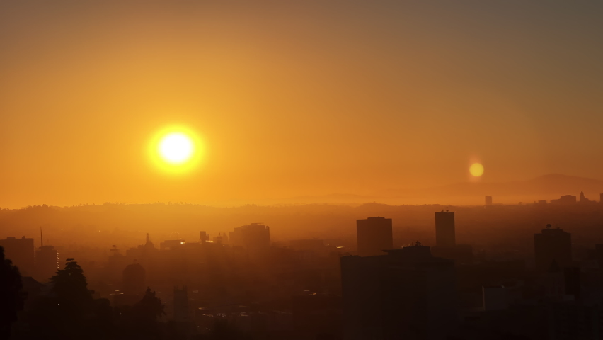 The red sun. The general plan of the city in the morning is the plan from above. Downtown Los Angeles Sunrise over the city, close-up on silhouettes of modern buildings in downtown Los Angeles. 4K UHD