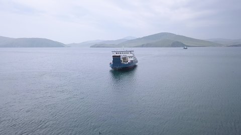 Russia, Olkhon - July 27, 2018: The mooring of the ferry Semen Batagayev. Lake Baikal. Ferry to Olkhon Island. From the side of the island., Aerial View Hyperlapse, Point of interest