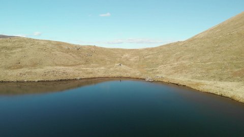 Lake District. Cumbria. April. 16. 2022. England. Flying over Bowscale Tarn drone footage.
