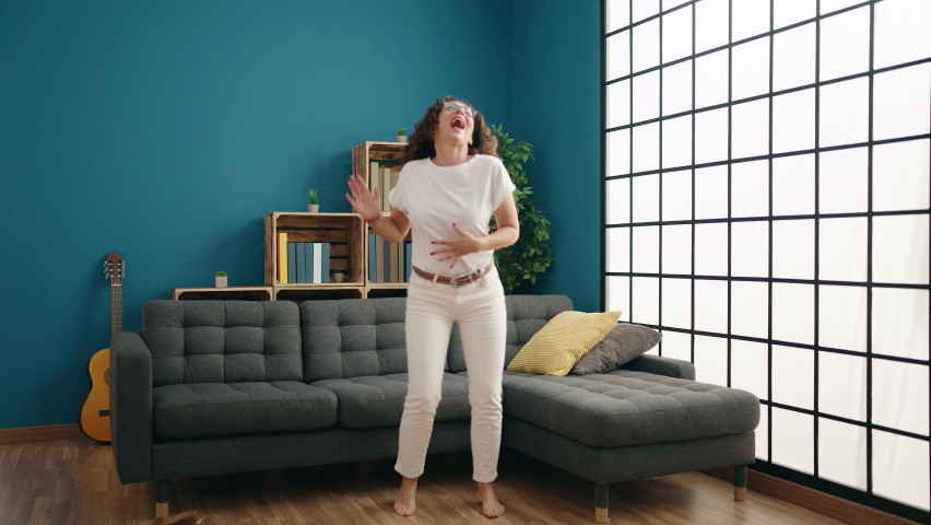 Middle age woman smiling confident dancing at home
